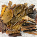 Assorted dried animal treats on a textured white surface