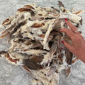 Bundle of natural rabbit ear dogs treats on marble surface